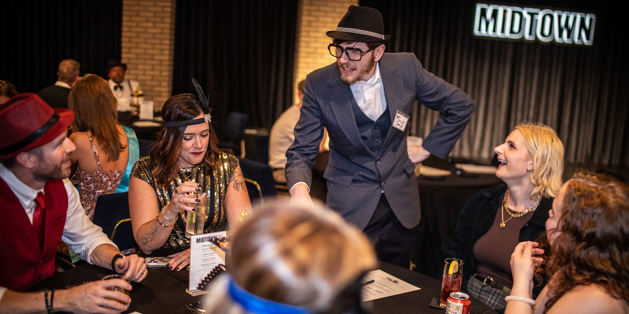 Guests at a Murder Mystery Company public dinner show in Denver